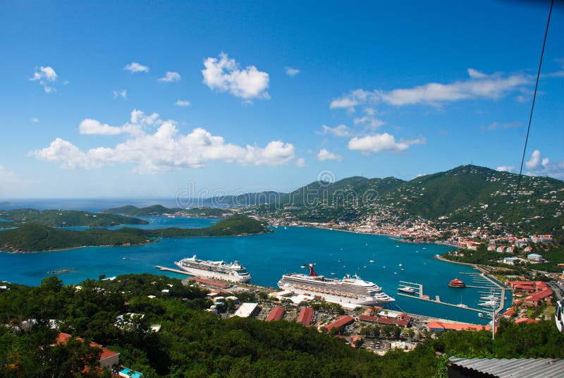 Caribbean island of St. Thomas, US Virgin Islands downtown harbor view with cruise ships on sunny day, surrounding buildings of Charlotte Amalie.