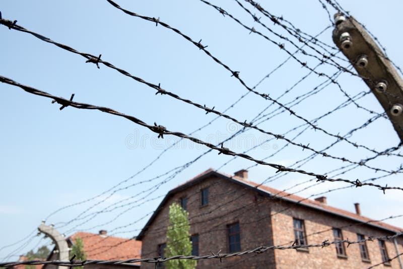 Stacheldraht und Baracken in Auschwitz stockbild