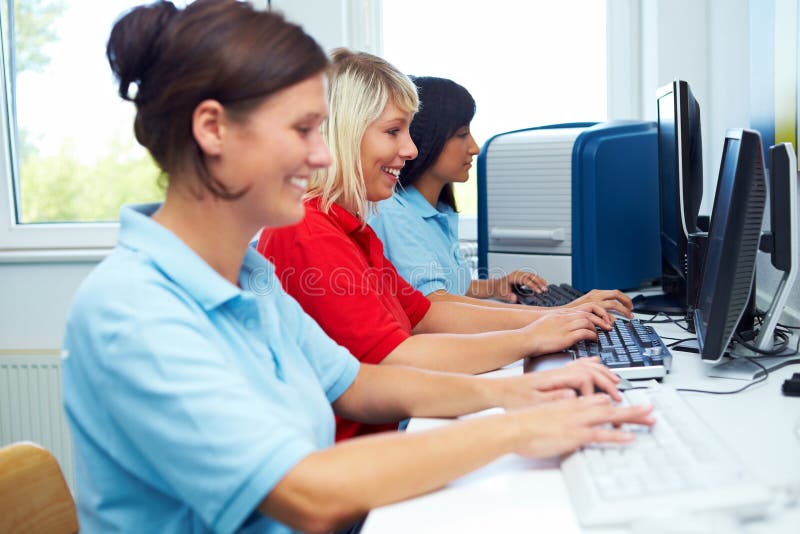 Female workers sitting on computer work stations. Female workers sitting on computer work stations