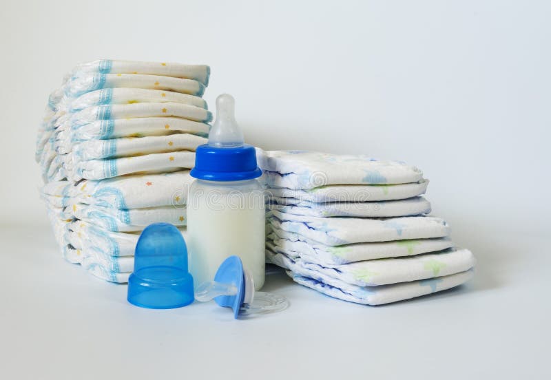 Stack of Baby Disposable Diapers, Pacifier and Electronic Thermometers ...