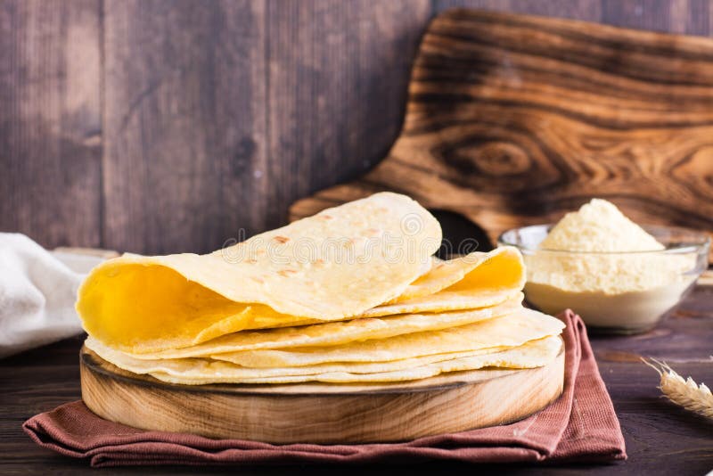 A Stack of Baked Mexican Tortillas on a Board on the Table. Homemade