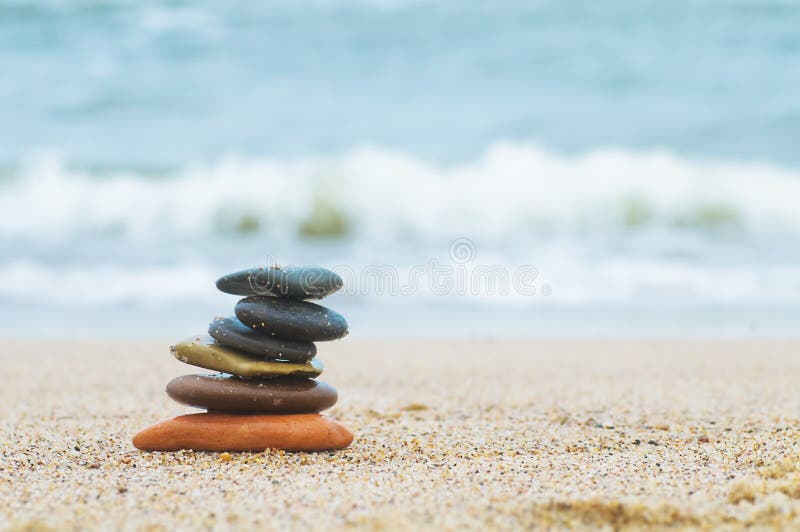 Stack of beach stones on sand