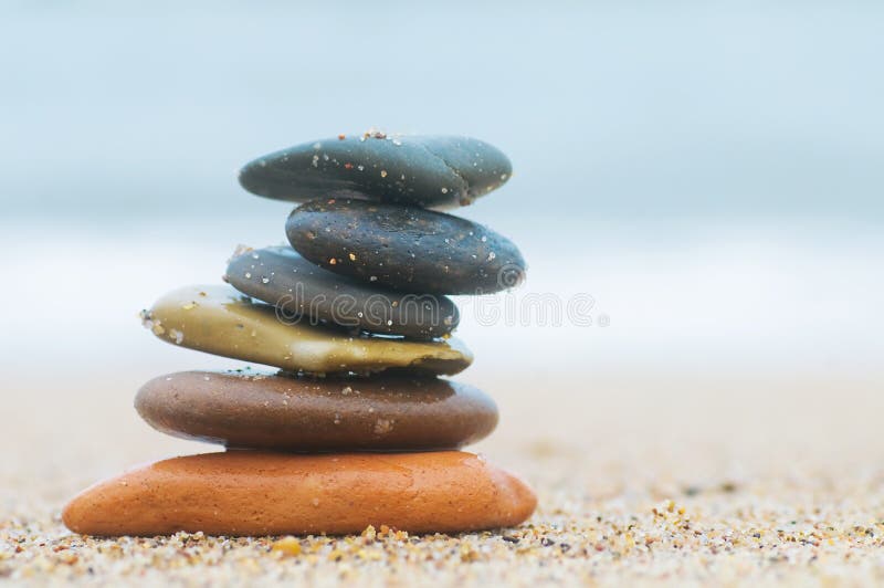 Stack of beach stones on sand