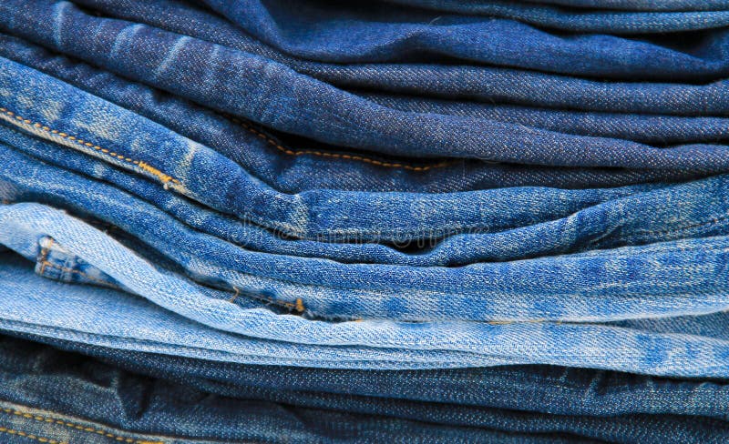 Stack of blue jeans close-up stock photo