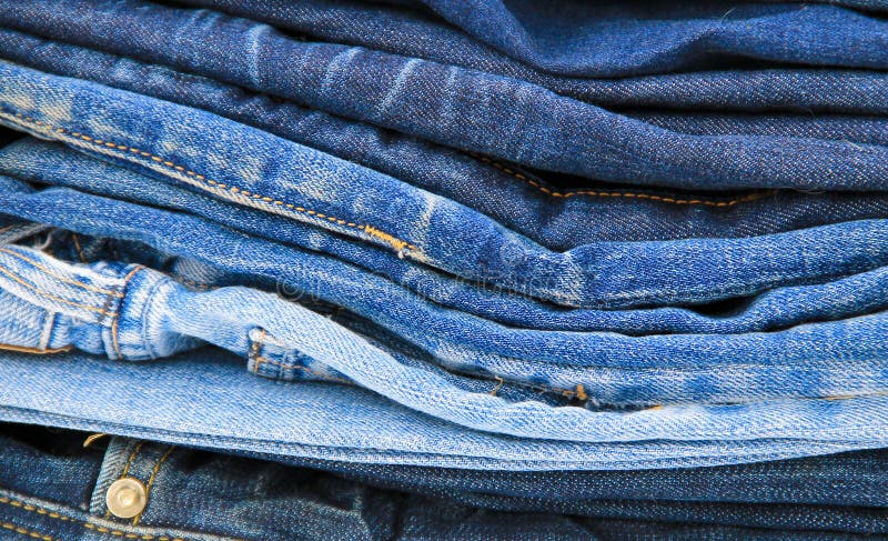 Stack of blue jeans close-up stock photo