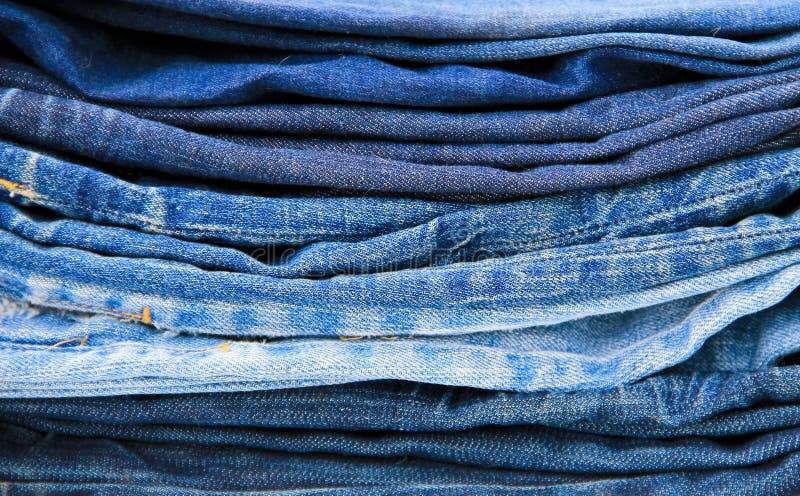 Stack of blue jeans close-up stock images