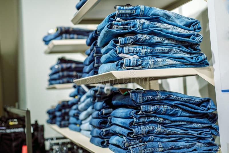 Stack of Blue Jeans in a Shop. Jeans Store Clearance Stock Image