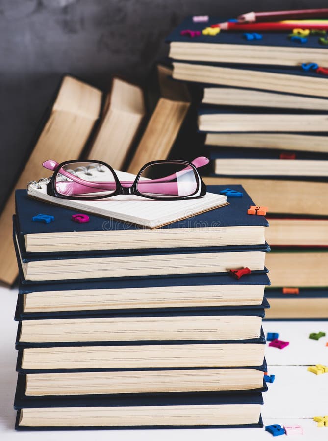 Stack of Books in a Blue Cover, Pink Glasses on Top Stock Photo Image