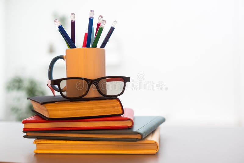 Stack of Books with Colored Spines, Colorful Pencils in a Cup Stock
