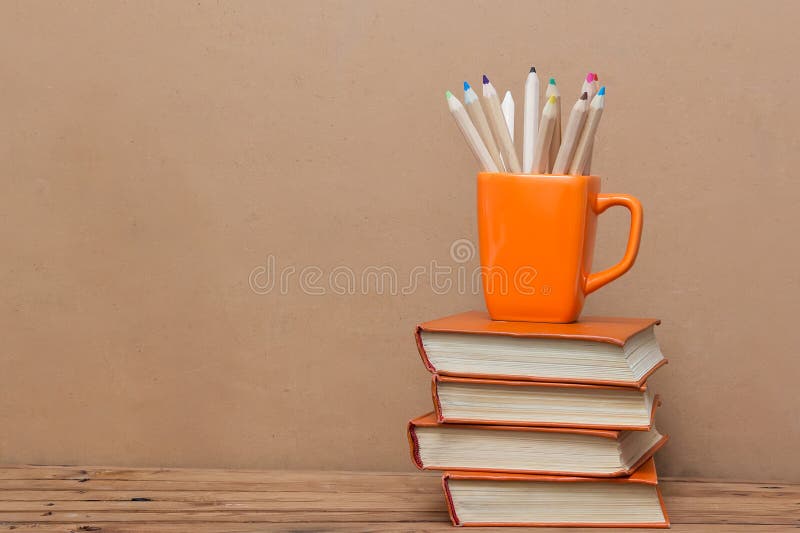 Stack of Books and a Cup with Colored Pencils Stock Image Image of