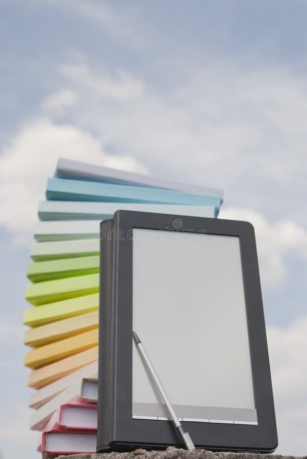 Stack of books and e-book reader