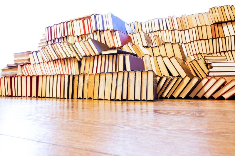 Stack of Books on the Floor Surronded by Windows Sunlight Stock Image