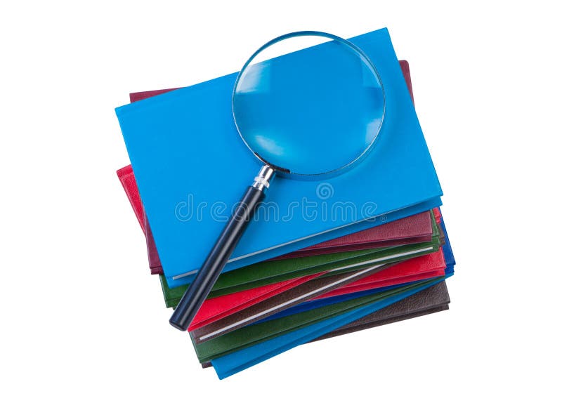 Stack of books with magnifer. stock images