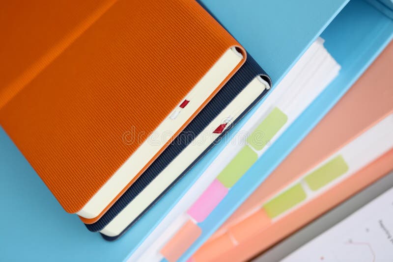 Stack of books with paper foder lie in office against table background. Business education concept. Old paper lie stock images, royalty-free photos and pictures