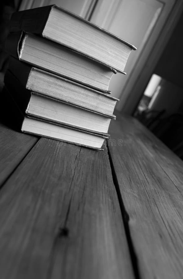 A Stack of Books on the Table. Black and White Photo. Books Stacked on ...