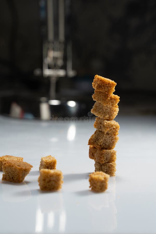 A stack of bread crackers on a white table with reflection