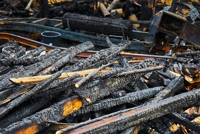 Stack of Burnt Wood after a Fire Damage, of Which only One Fire Ruin Remained Stock Photo