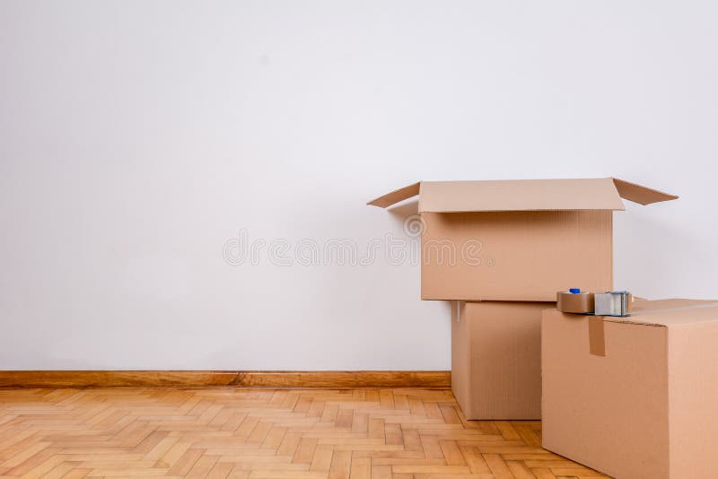 Stack of cardboard boxes in the empty room royalty free stock images