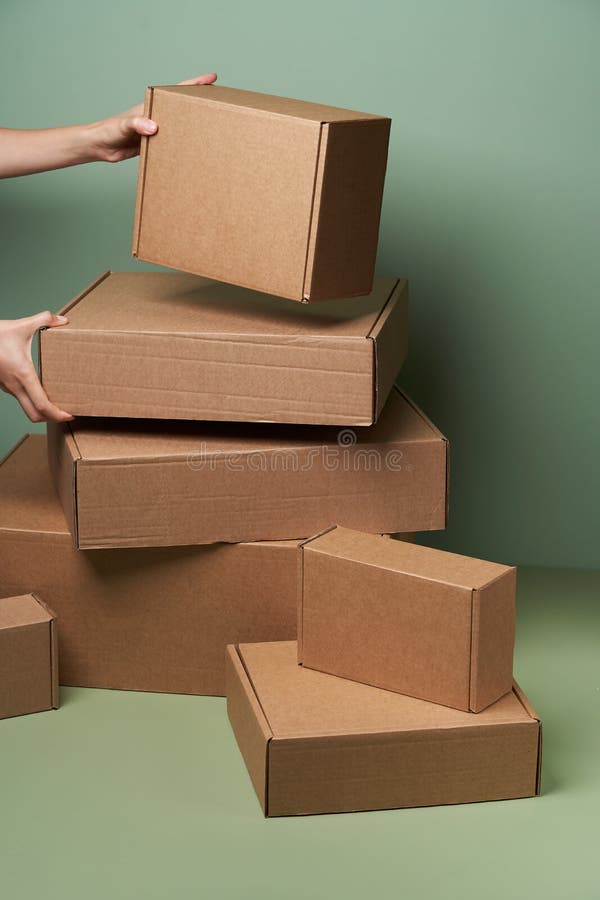 Stack of Cardboard Boxes on Pastel Color Background with Copy Space