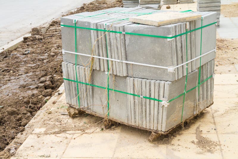 Stack of Cement Floor Tiles at Road Side Construction Site Stock Photo