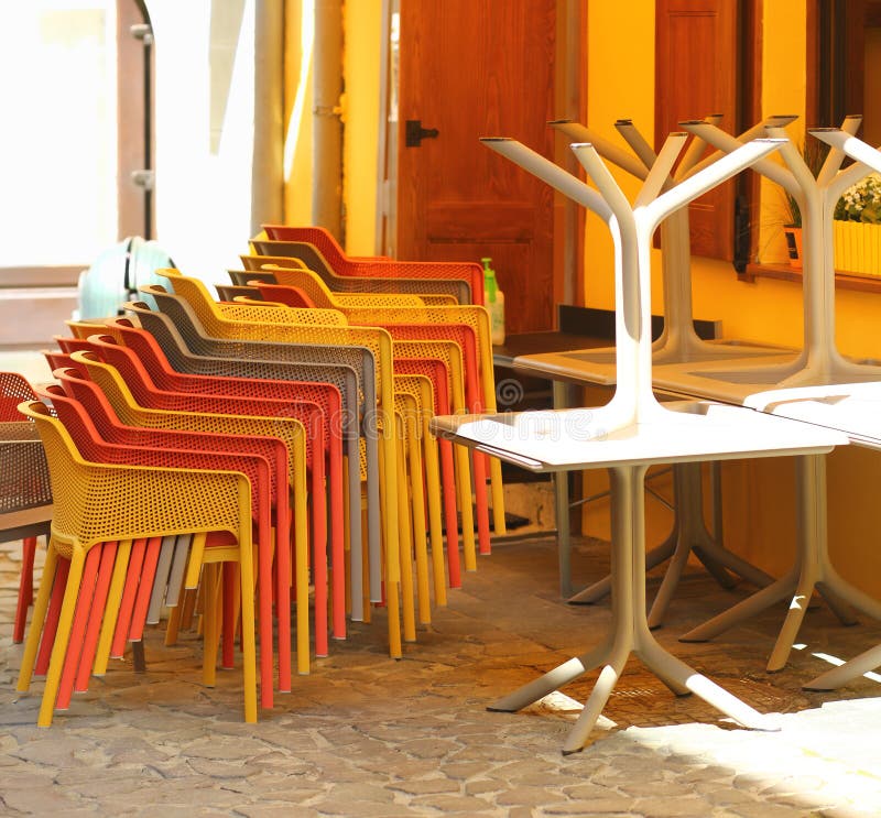 Stack of chairs and tables in the closed morning street cafe terrace stock photography Stack of chairs and tables in the closed morning street cafe terrace stock photography