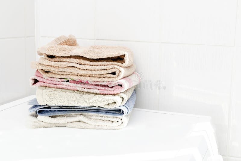Stack of Clean Fluffy Towels on Washing Machine in Bathroom.laundry