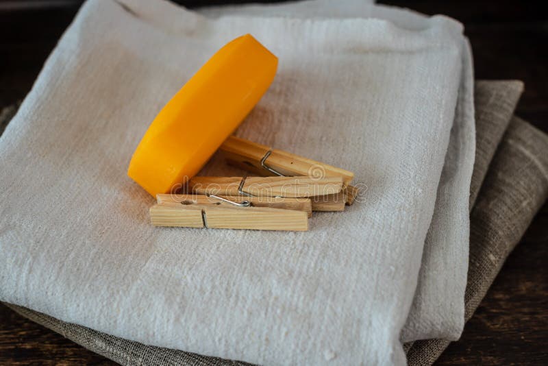 Stack of clean linen towels, clothespins and natural soap on table stock photo Stack of clean linen towels, clothespins and natural soap on table stock photo