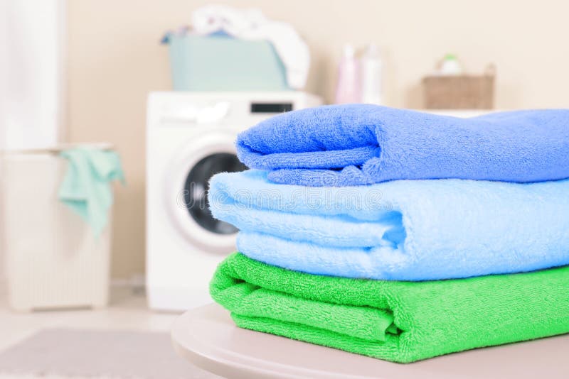 Stack of Clean Towels on Table in Laundry Room. Stock Image Image of