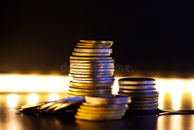 A stack of coins against the background of bright light, the financial crisis in all its glory close-up royalty free stock images A stack of coins against the background of bright light, the financial crisis in all its glory close-up royalty free stock images