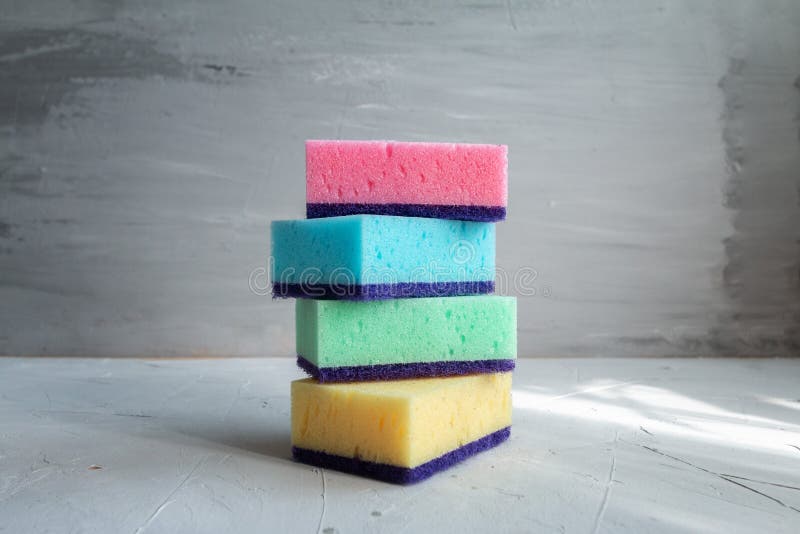 Stack of Colored Sponges for Washing Dishes Against Grey Background