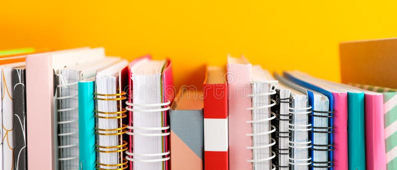 Stack of colorful books against background