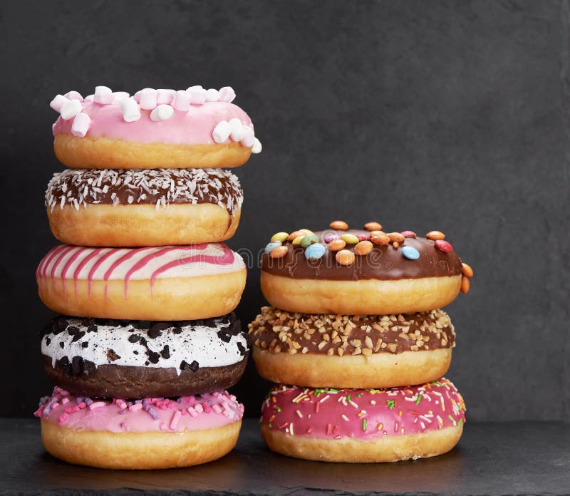 Stack of Colorful Donuts on a Stone Table Stock Image - Image of stack ...