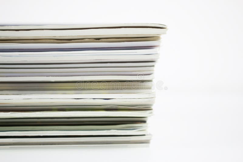 A stack of colored magazines on a white background, vertical. A stack of colored magazines on a white background, vertical.