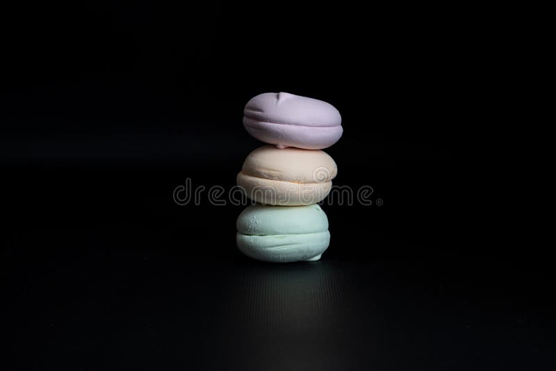 A Stack of Colorful Marshmallows on a Black Background Stock Photo