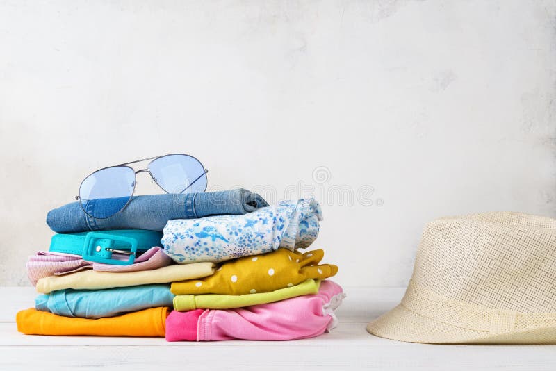 Stack of colorful summer clothes and accessories.