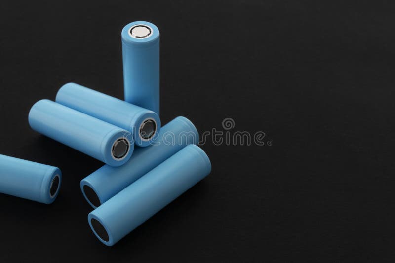 Stack of 18650 cylindrical batteries on black background, rechargeable lithium-ion batteries royalty free stock image