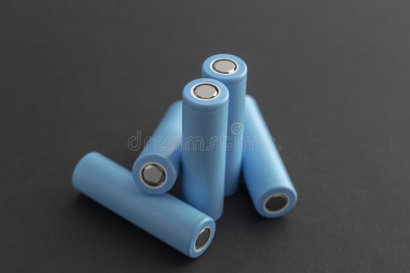 Stack of 18650 cylindrical batteries on black background royalty free stock images