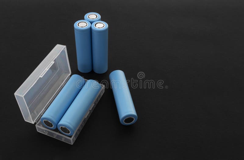 Stack of 18650 cylindrical batteries on black background royalty free stock image