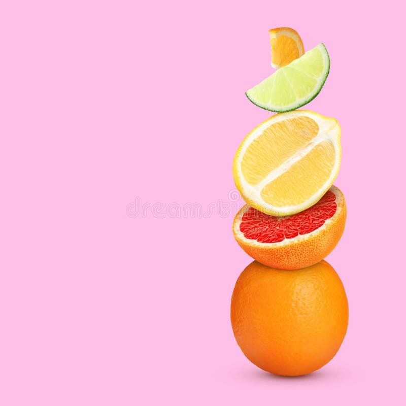 Stack of Different Fresh Citrus Fruits on Pale Pink Background, Space