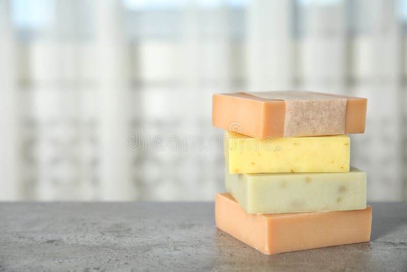 Stack of different handmade soap bars on table stock photography