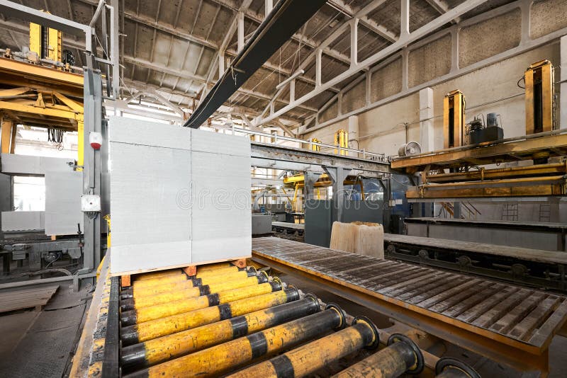 Stack of Finished Blocks on Roller Conveyor at Plant Stock Photo