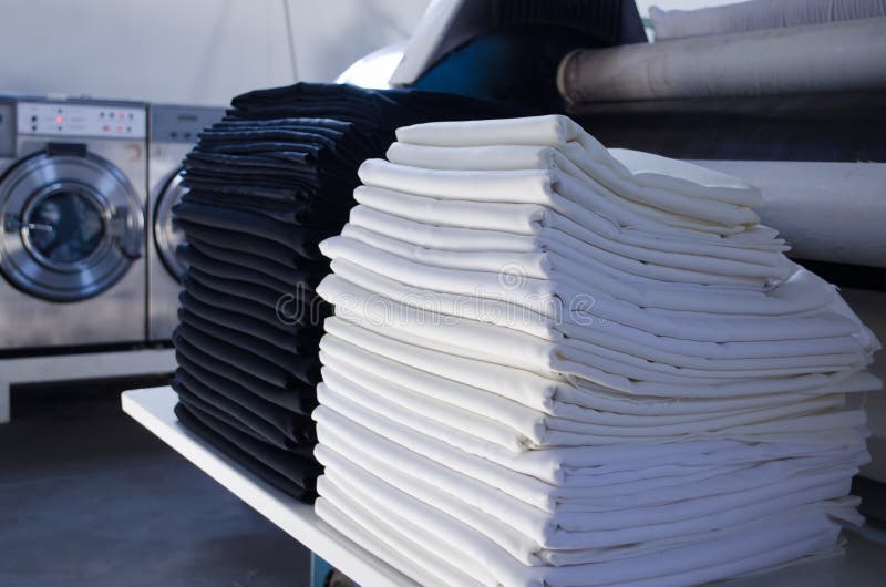 Stack of Folded Black and White Cloths in an Industrial Laundry Stock ...