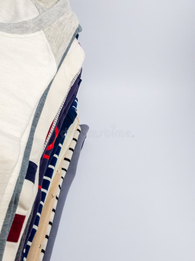 Stack of Folded Clothes against a Plain Background with Copy Space royalty free stock image