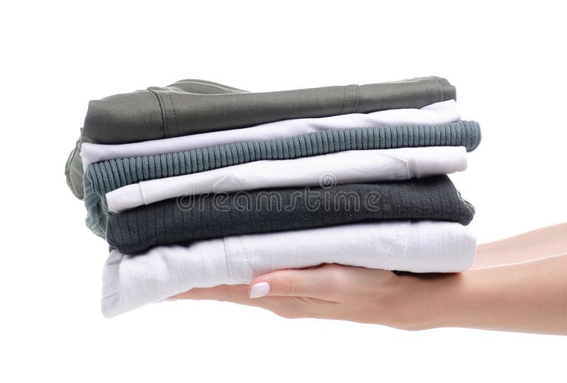Stack folded green white clothing in hand stock photo