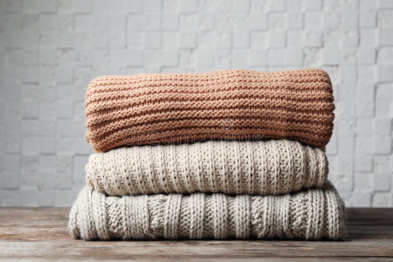 Stack of Folded Knitted Sweaters on Table Stock Photo - Image of ...