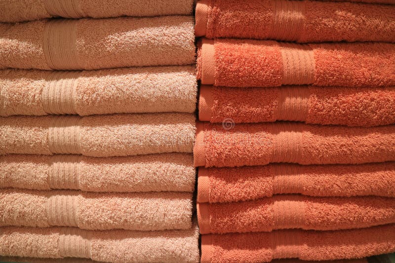 Stack of Folded Many Tones of Orange Color Bath Towels Stock Photo