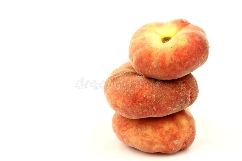 Stack of fresh colorful flat peaches stock photos