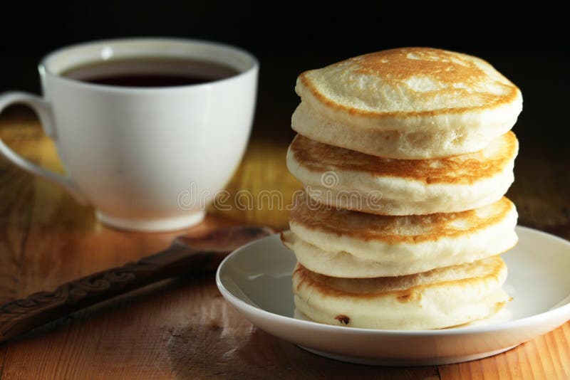 A Stack of Freshly Backed Pancakes and a Cup of Coffee Stock Photo