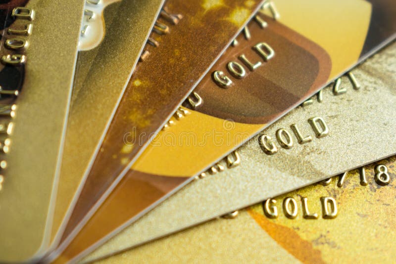 Stack of gold credit cards on dark background, close up view wit royalty free stock photography Stack of gold credit cards on dark background, close up view wit royalty free stock photography