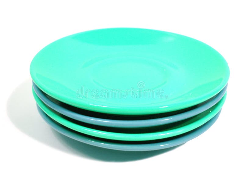 Stack of green and blue plates on white background